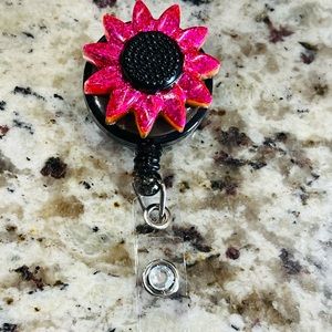 Pink purple sunflower badge reel.